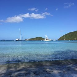 Sailboats on sea against sky