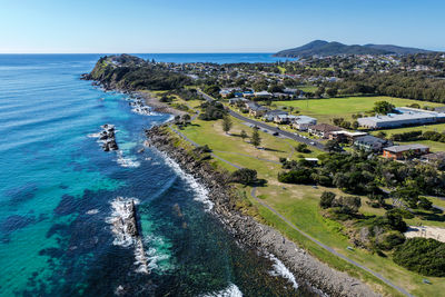 High angle view of townscape by sea against sky