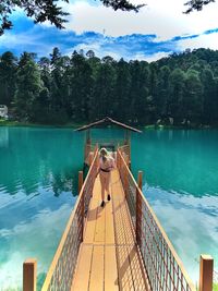 Scenic view of swimming pool by lake against sky