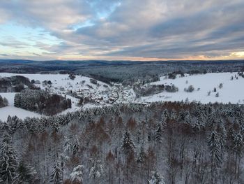 Scenic view of lake against sky during winter