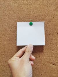 High angle view of hand holding paper