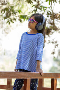 Smiling girl wearing headphones outdoors