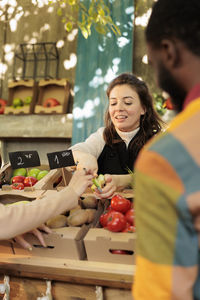 Portrait of woman holding food at market