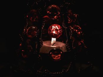 Close-up of illuminated lighting equipment against black background