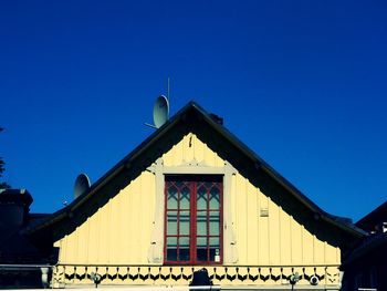 Low angle view of building against clear blue sky