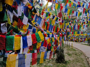 Multi colored flags hanging on alley