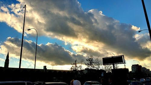 Low angle view of parking lot against cloudy sky