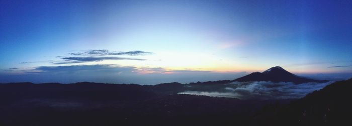 Scenic view of silhouette mountains against sky during sunset