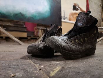 Close-up of abandoned shoes on floor