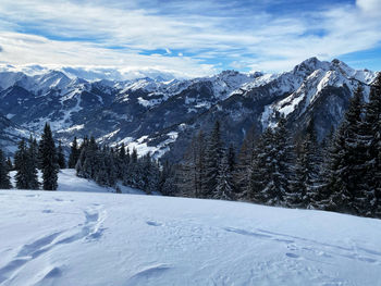 Scenic view of snowcapped mountains against sky