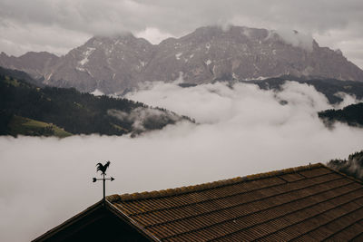 Houses on mountain against sky