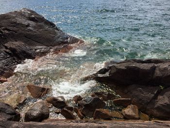 Rock formation in sea against sky