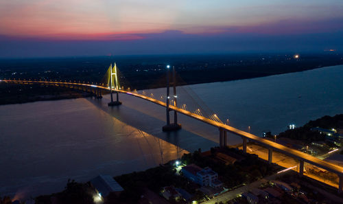 High angle view of illuminated bridge against sky during sunset