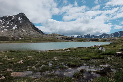 Scenic view of lake against cloudy sky