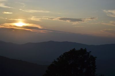 Low angle view of silhouette mountains against sky at sunset