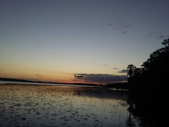 Scenic view of sea against sky at sunset