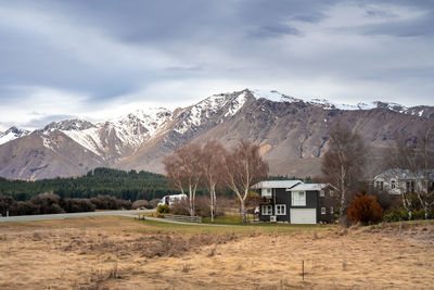 Sunrise view of the housing estate at lake tekapo in late winter with beautiful snow capped mountain