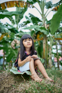 Portrait of young woman sitting outdoors