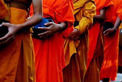 Midsection of monks wearing traditional clothing while standing in row