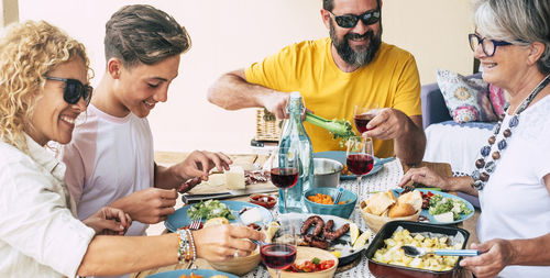 High angle view of family having meal while sitting at home