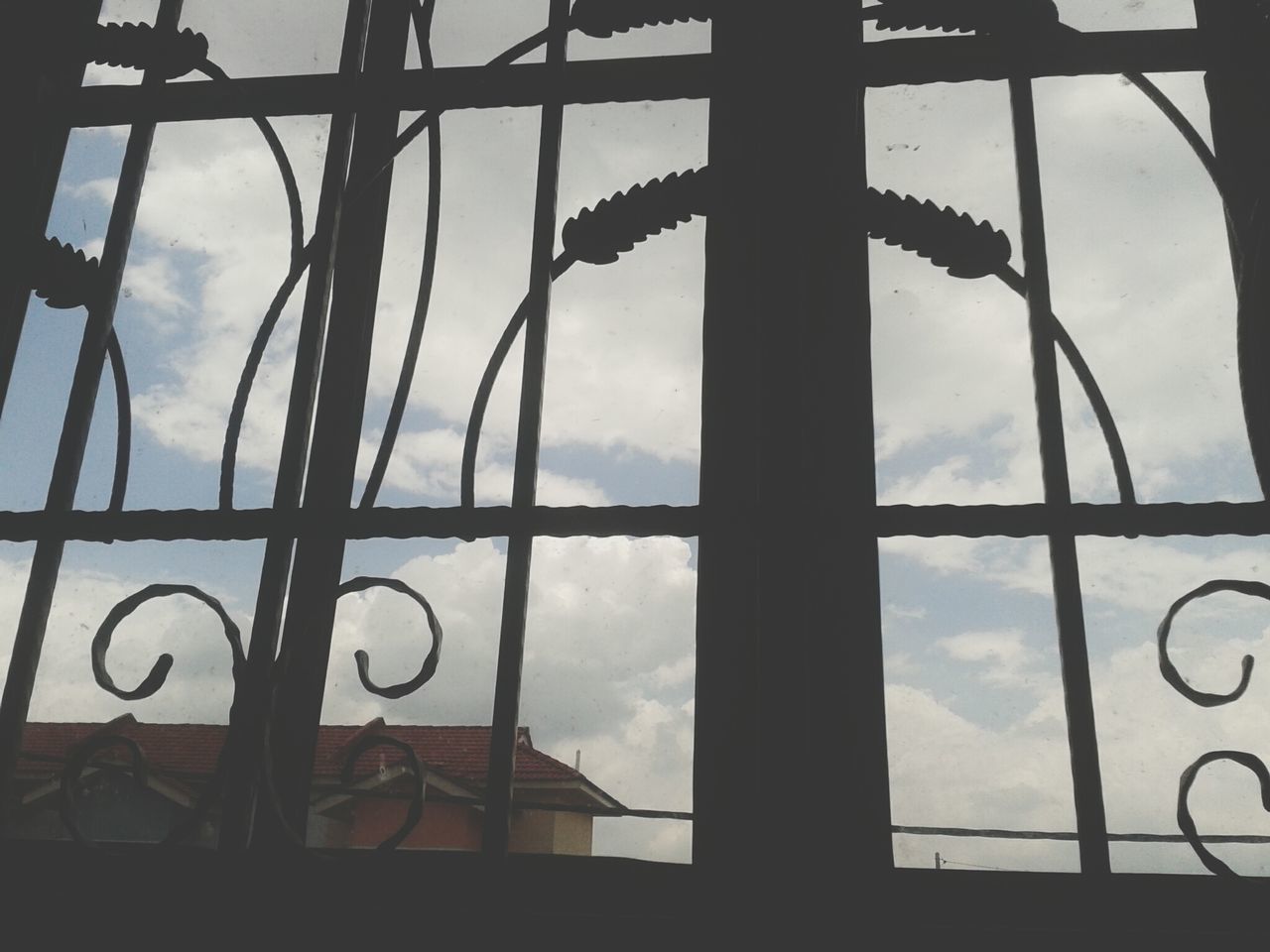 sky, cloud - sky, cloudy, low angle view, silhouette, cloud, metal, built structure, window, weather, architecture, overcast, dusk, day, no people, indoors, metallic, fence, safety