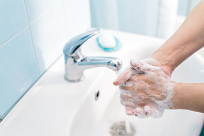 Midsection of woman in bathroom at home