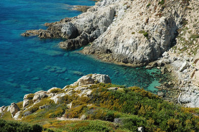 High angle view of rocks by sea