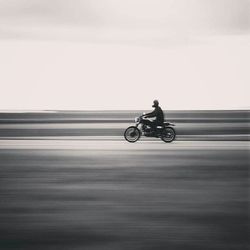 Blurred motion of man riding bicycle