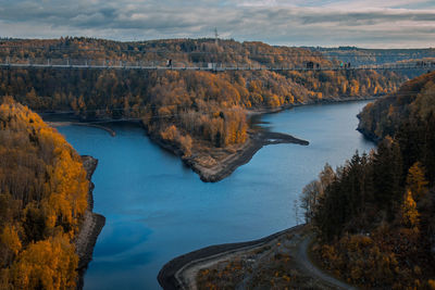 High angle view of river amidst rocks against sky