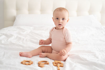 Cute baby boy sleeping on bed at home