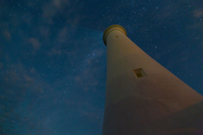 Low angle view of lighthouse against sky at night