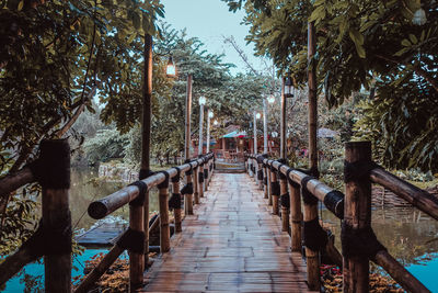 The bridge made of bamboo has a beautiful design that is artfully blended with nature and the river