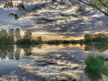 Scenic view of lake against sky during sunset