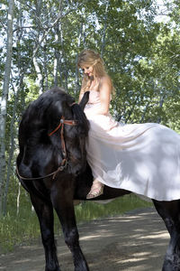 Teenage girl riding horse