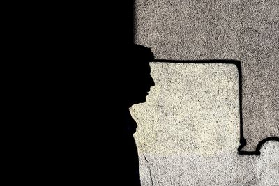 Side view of silhouette person against wall