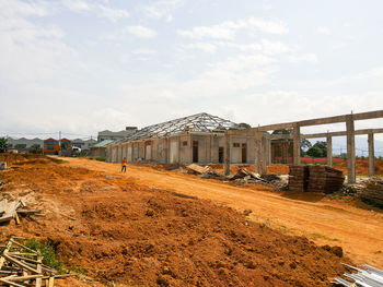 Panoramic view of railroad tracks amidst buildings against sky