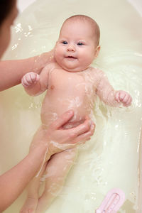 Cropped image of woman swimming in sink