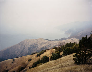 Big sur mountains in morning with layer of smoke from forest fir