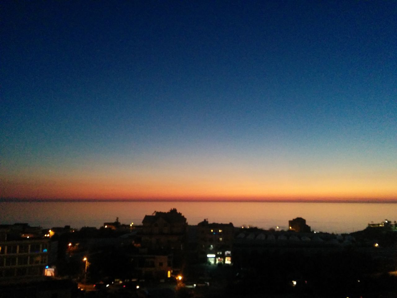 SILHOUETTE CITY AGAINST SKY AT NIGHT