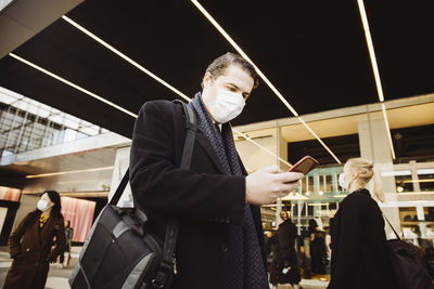 Man walkin in street wearing face mask