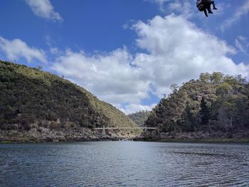 Scenic view of lake by trees against sky