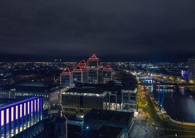 High angle view of buildings lit up at night