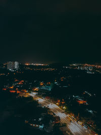 High angle view of illuminated city buildings at night