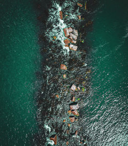 Aerial view of rocks in sea