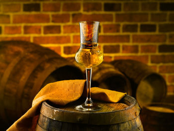 Close-up of wineglass on table against wall