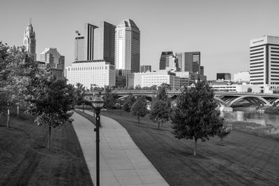 Trees and buildings against clear sky