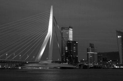 B and w late afternoon shot of rotterdam erasmus bridge in the last sunlight, with vessel passing.