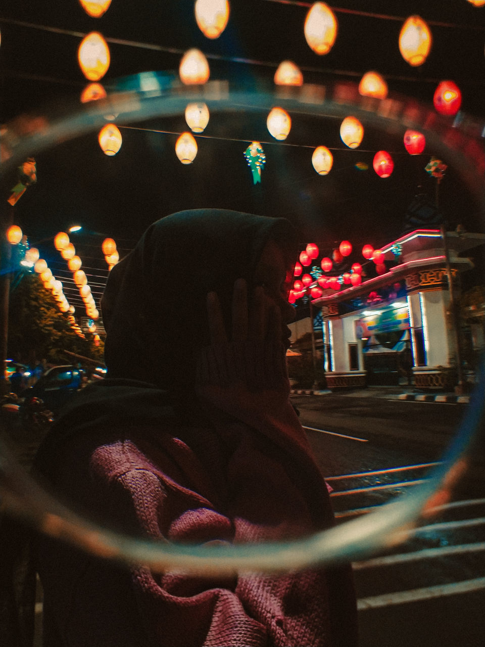 REAR VIEW OF WOMAN SEEN THROUGH CAR WINDSHIELD