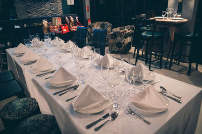 Wineglass and plates arranged on dinning table at restaurant