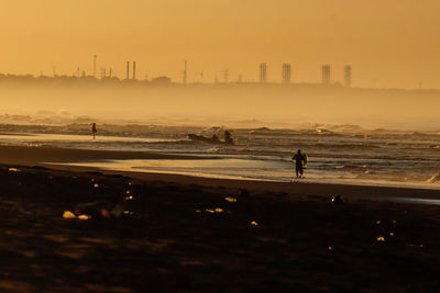 Silhouette people at beach